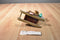 Russ Sleds Brown Teddy Bear Plush on a Wooden Sled